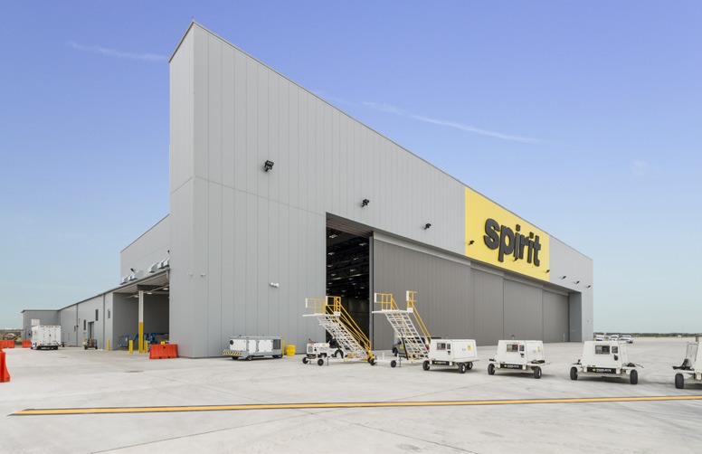 Butler metal aircraft hangar with engineered steel framing and optional sliding, bifold, or hydraulic hangar doors for any size airplane.