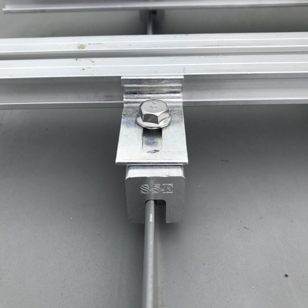 S-5-E clamp installation diagram showing placement on double-fold standing seam roof profile Torx Drive T30 setscrew tightening sequence and M8 bolt attachment for solar panels and rooftop accessories