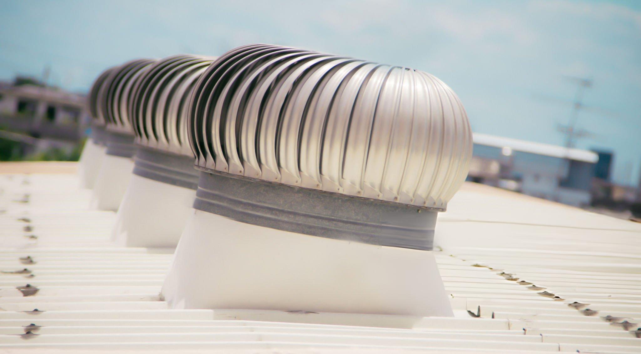 Butler turbine vent integrated into a Butler standing seam or corrugated metal roof system showing weathertight curb base flashing and roof panel compatibility for long-term ventilation performance