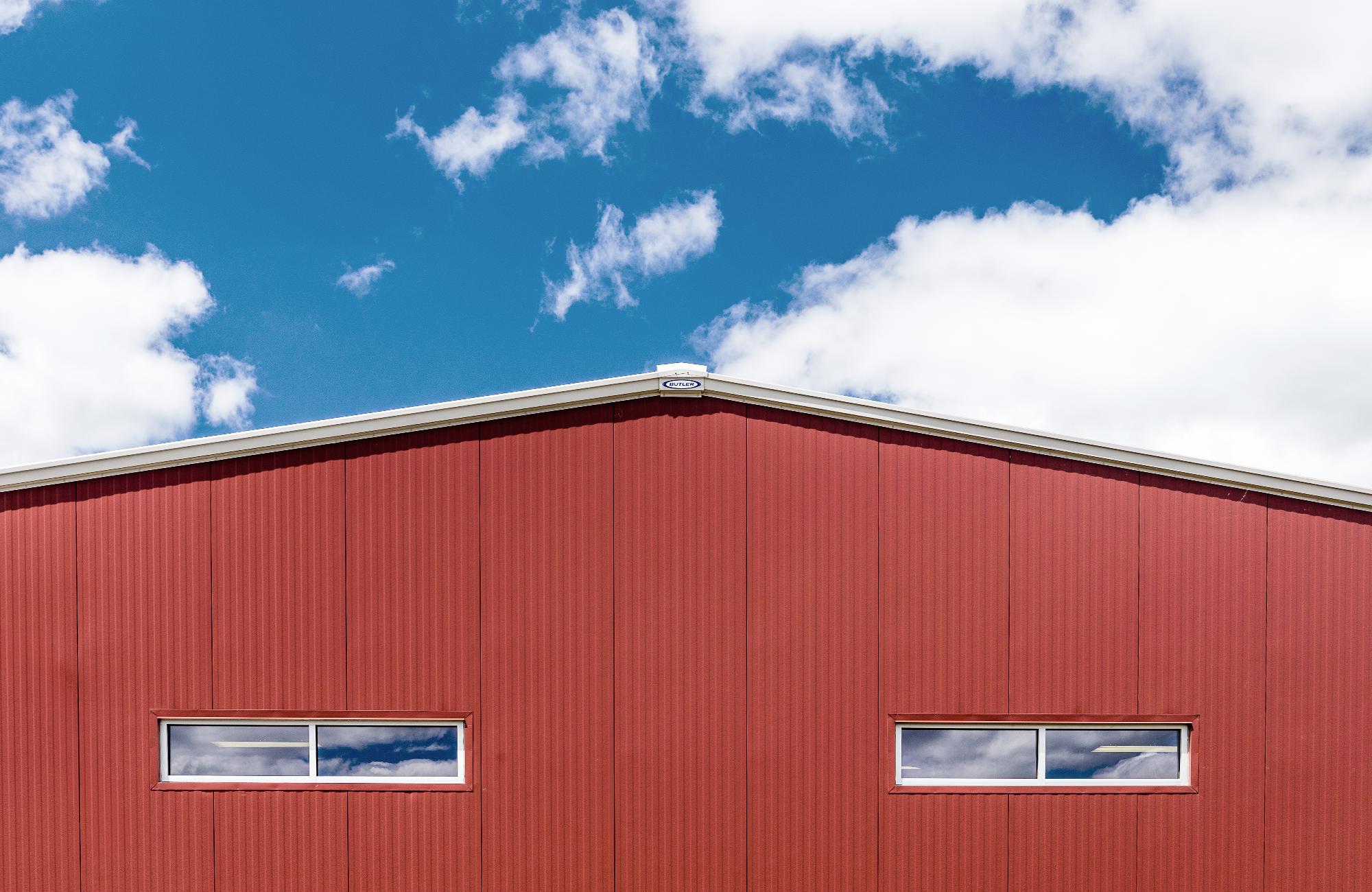 Butler Thermawall Fineline insulated metal sandwich panel IMP installed on a high-end commercial or industrial building showing shallow precision-formed vertical grooves soft shadow lines concealed tongue-and-groove fastener system and continuous weathertight building envelope