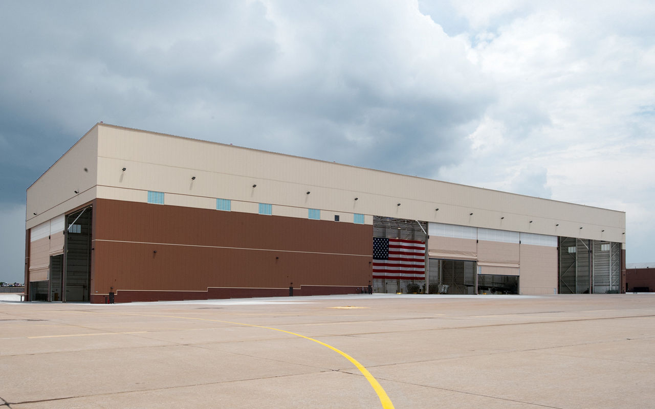 Structural steel framing and track system for Butler aircraft hangar doors on a pre-engineered metal building