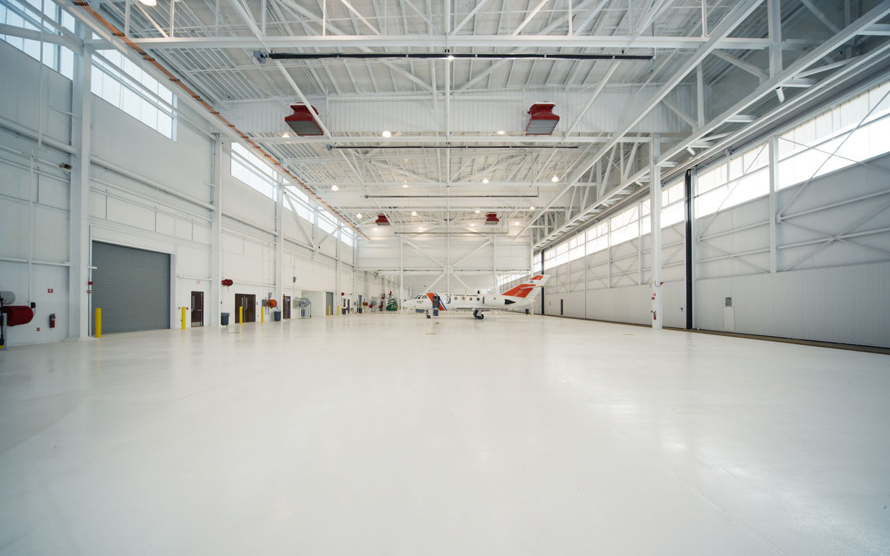 Butler metal aircraft hangar with large hangar door opening allowing airplane storage and aviation facility access