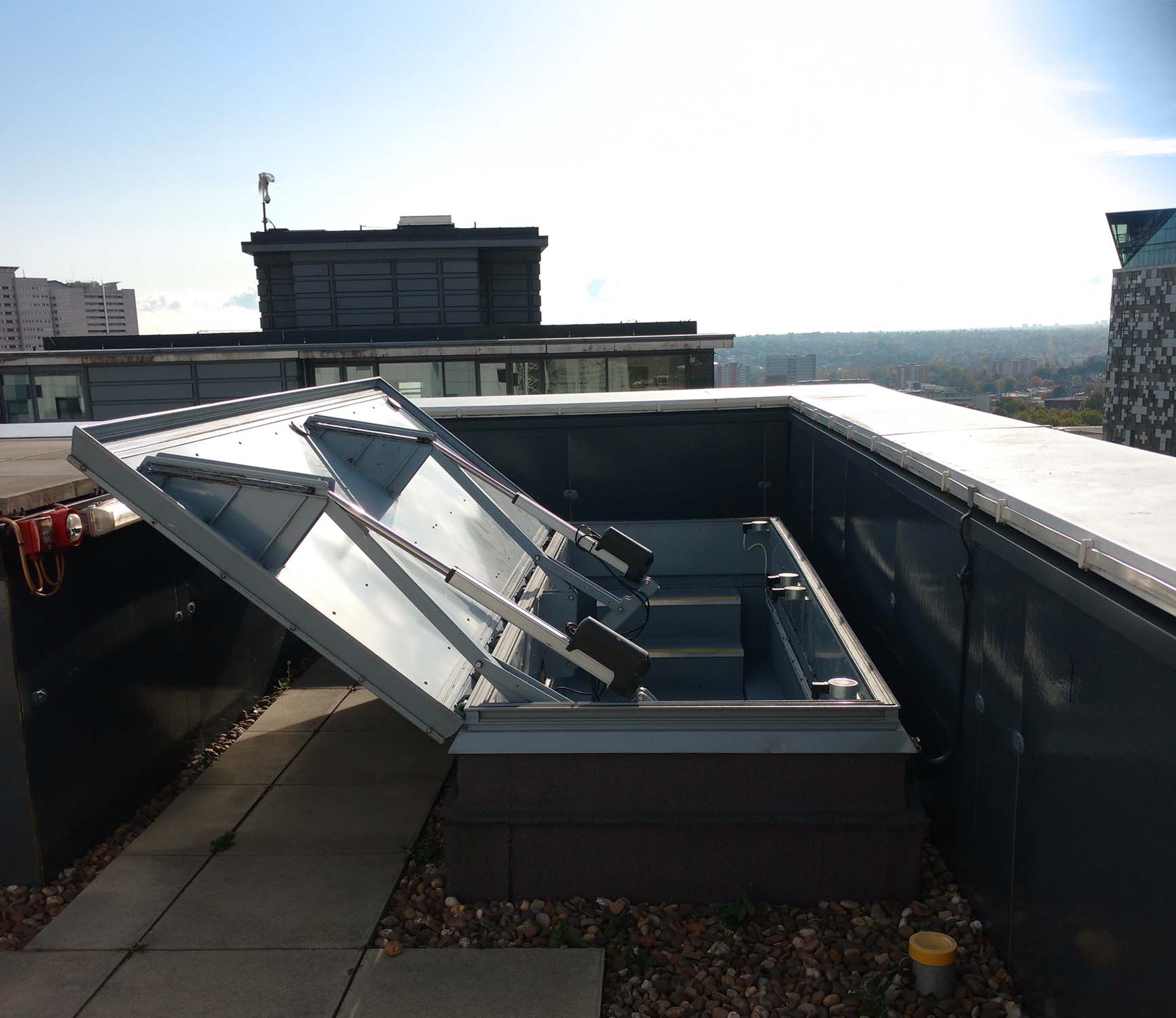 Butler compatible smoke ventilator and smoke hatch system constructed from galvanized steel stainless steel or aluminum with heavy duty hardware for long term weather resistance and wind uplift performance