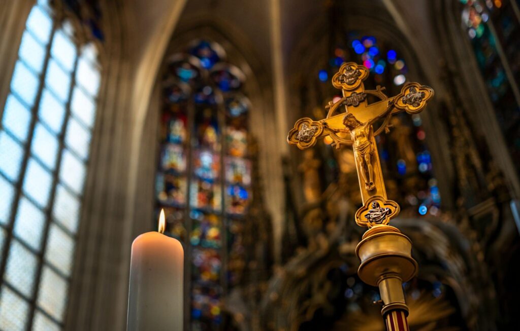 Butler Golden crucifix inside cathedral with stained glass