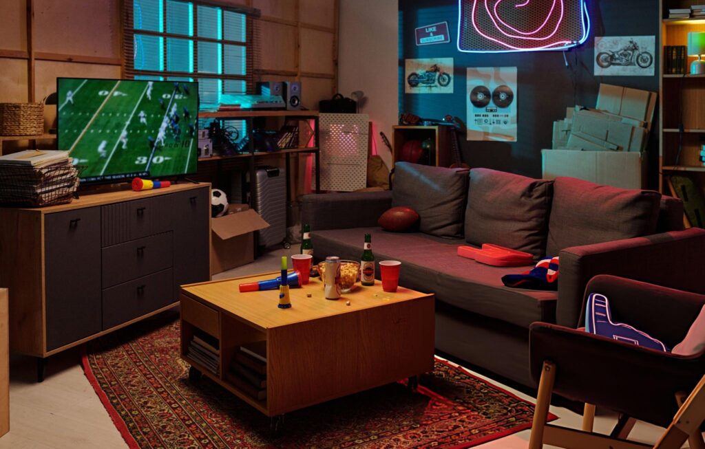 Butler Man Cave Empty Living Room Showing Football Game on Television during Evening Gathering