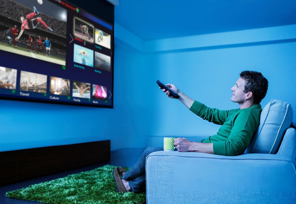 Butler Man watching television in living room