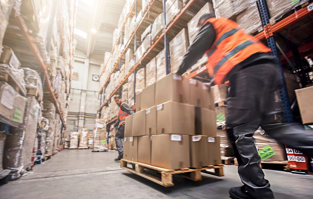 Butler two men moving boxes in a warehouse